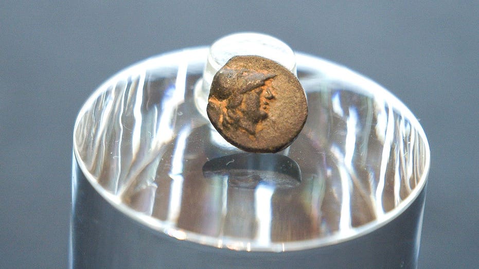 Teen stumbles on mysterious coin from legendary city, puzzling archaeologists over its journey Education QLD